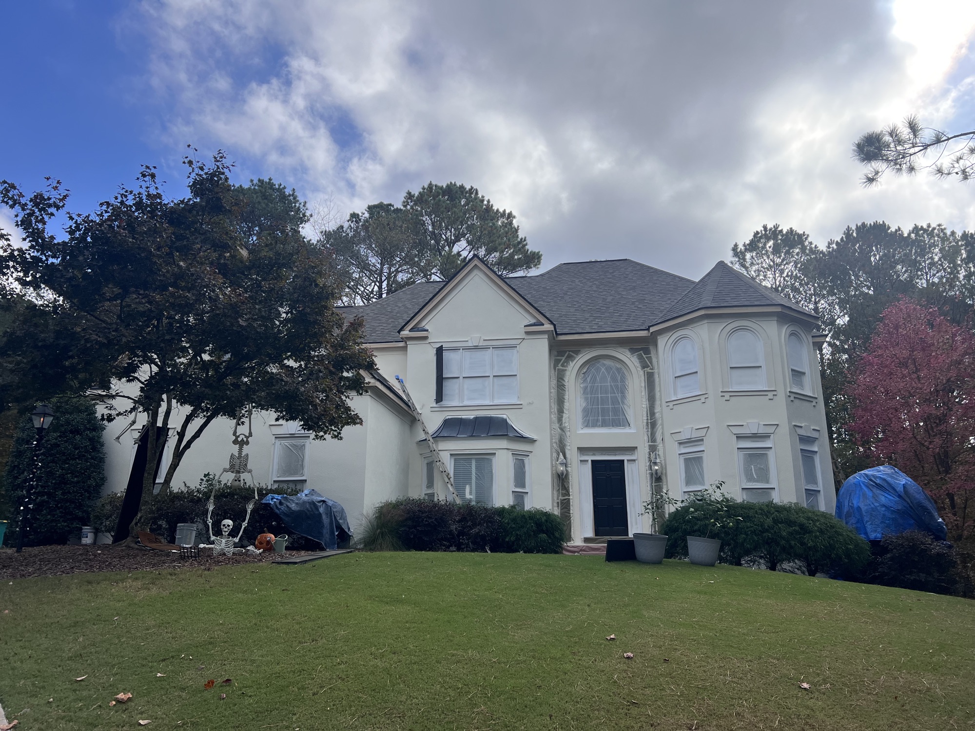 An Elite Finishes crew painting a home exterior in North Atlanta on a clear summer morning